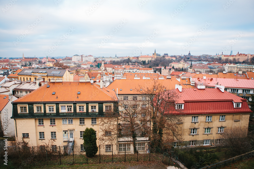View from a high point. A beautiful view from above on the streets, roads and roofs of houses in Prague. Traditional ancient urban architecture. View from a high point. A beautiful view from above on the streets, roads and roofs of houses in Prague. Traditional ancient urban architecture.