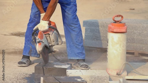 MOSCOW, RUSSIA, JULE 24, 2016: Construction Worker Cutting Concrete Block With Circular Saw