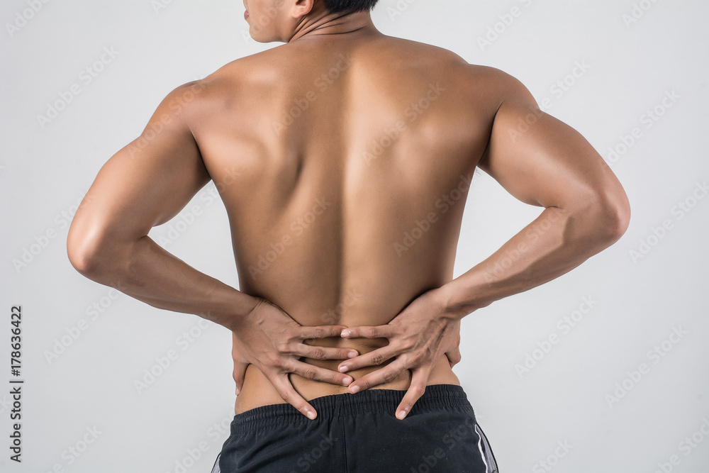 Close up of man rubbing his painful back isolated on white background.