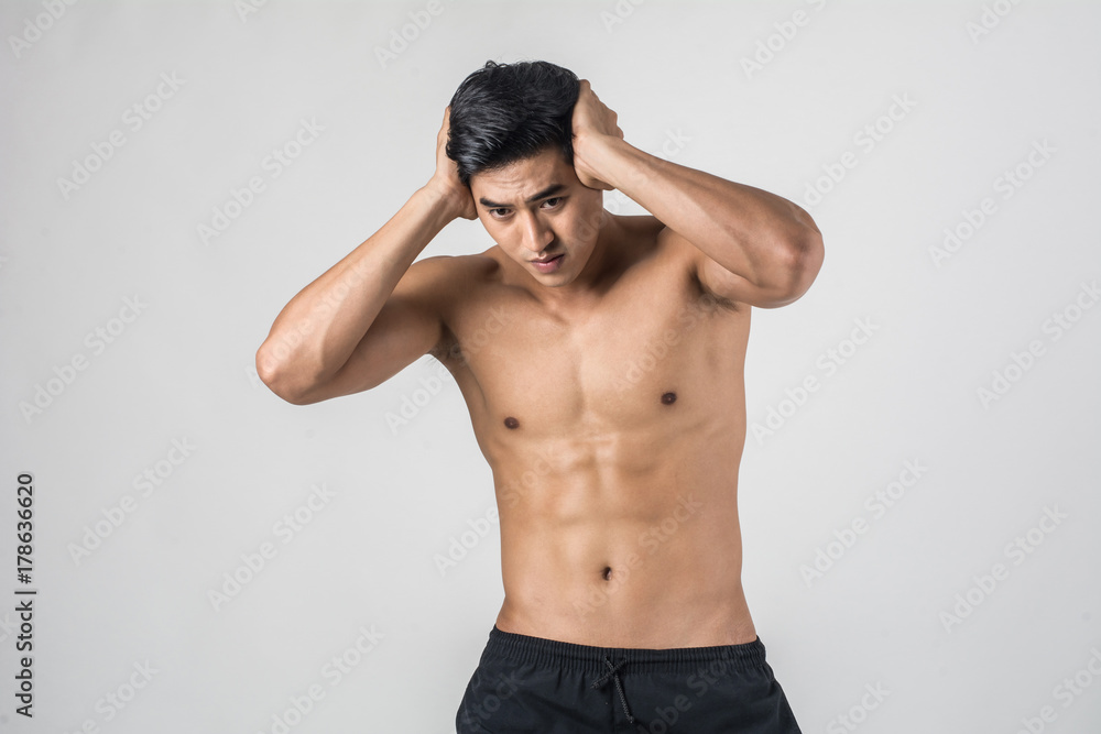Fototapeta premium Young handsome Muscular man has headache isolated on white background.