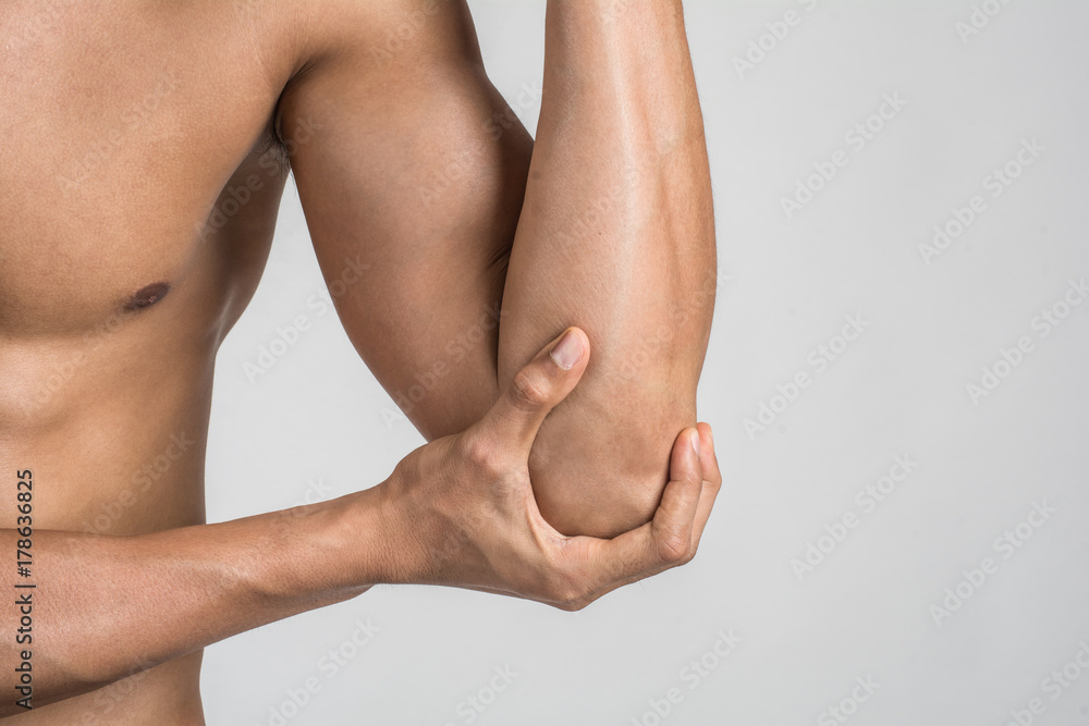 Portrait of a muscle man having elbow pain isolated on white background Portrait of a muscle man having elbow pain isolated on white background