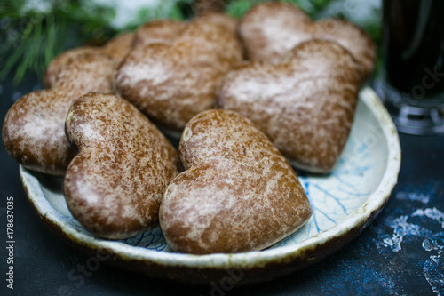 Christmas gingerbreads in the form of heart. Christmas composition on the background of fir-tree branches © yusev