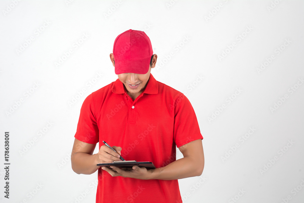 Young delivery man checking list on clipboard isolated on white background Young delivery man checking list on clipboard isolated on white background