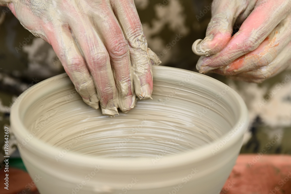 Potter making ceramic pot on the pottery wheel