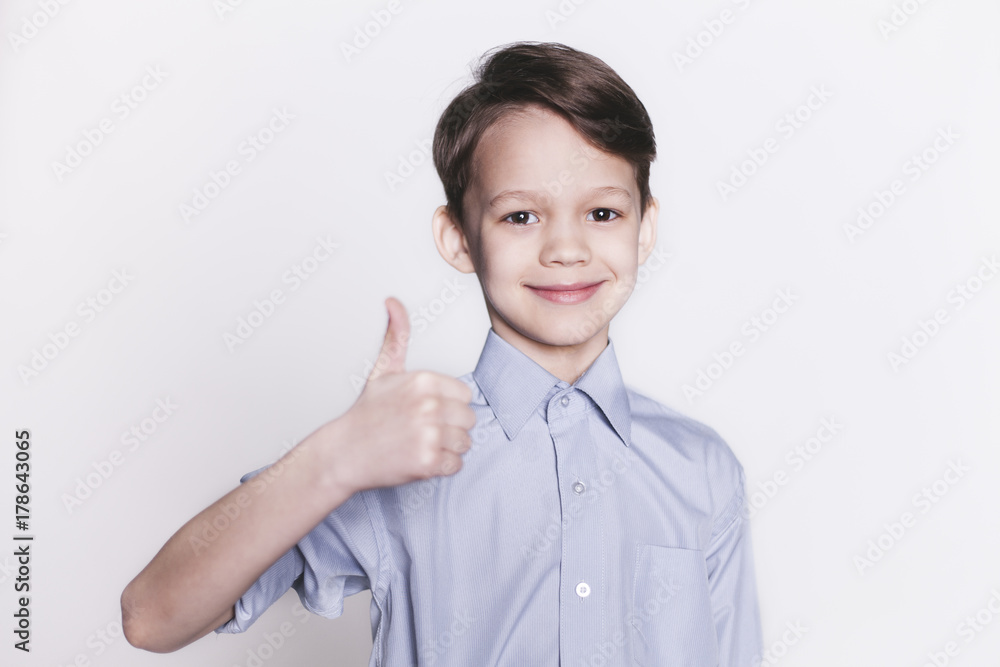 Portrait of cheerful brunette boy showing thumb up gesture, isolated. Portrait of cheerful brunette boy showing thumb up gesture, isolated.