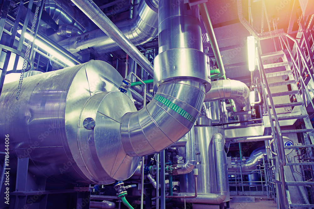 Equipment, cables and piping as found inside of a modern industrial power plant Equipment, cables and piping as found inside of a modern industrial power plant