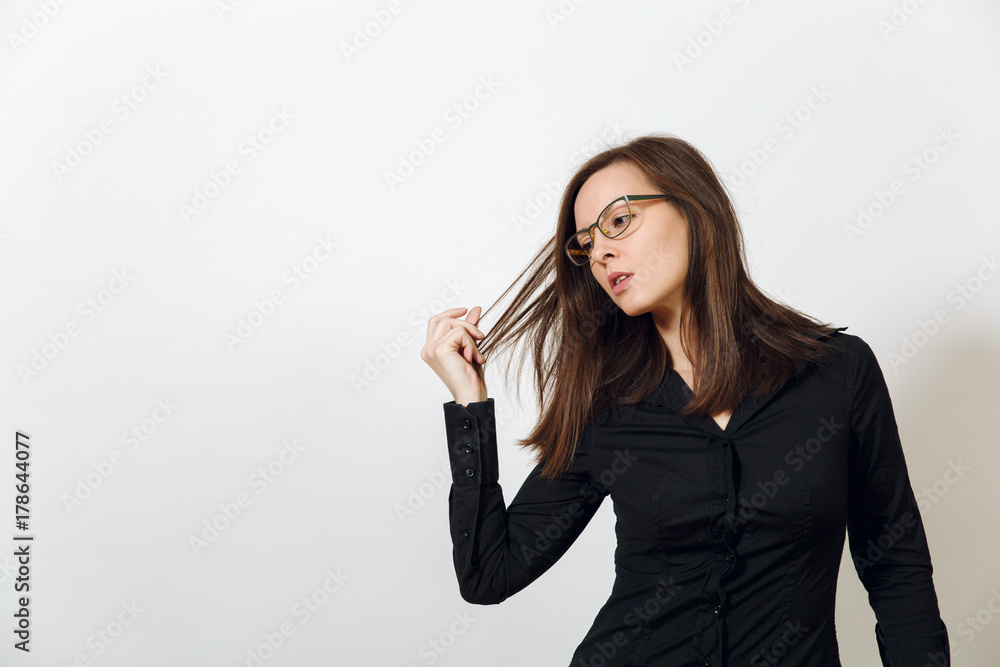 Beautiful European young sexy brown-haired woman in glasses for sight with healthy clean skin and charming smile, dressed in a dark black shirt enjoying on a white background. Emotions concept. Beautiful European young sexy brown-haired woman in glasses for sight with healthy clean skin and charming smile, dressed in a dark black shirt enjoying on a white background. Emotions concept.