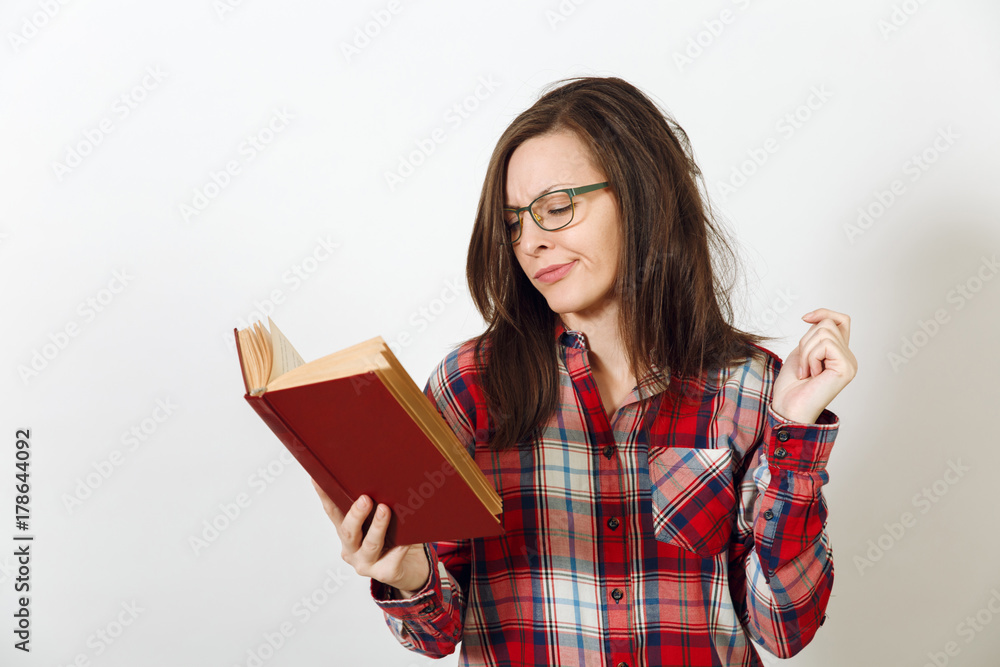 Beautiful European young brown-haired woman in glasses for sight with healthy clean skin dressed in casual red plaid shirt, standing with the book on a white background. Reading and studying concept. Beautiful European young brown-haired woman in glasses for sight with healthy clean skin dressed in casual red plaid shirt, standing with the book on a white background. Reading and studying concept.