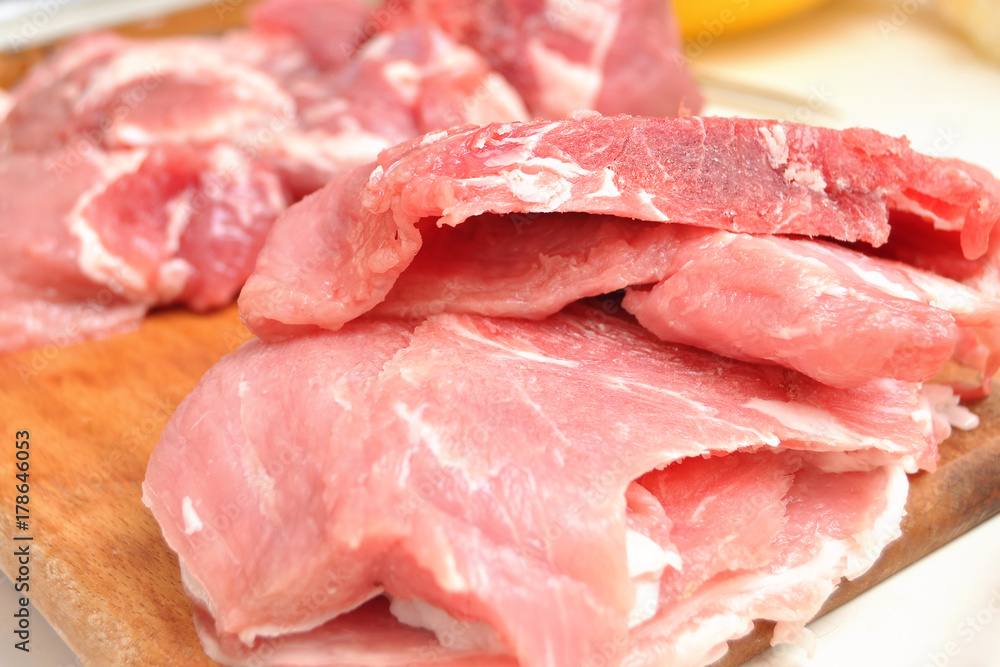 Raw chopped pork on the cutting board close-up. Process of cooking Raw chopped pork on the cutting board close-up. Process of cooking