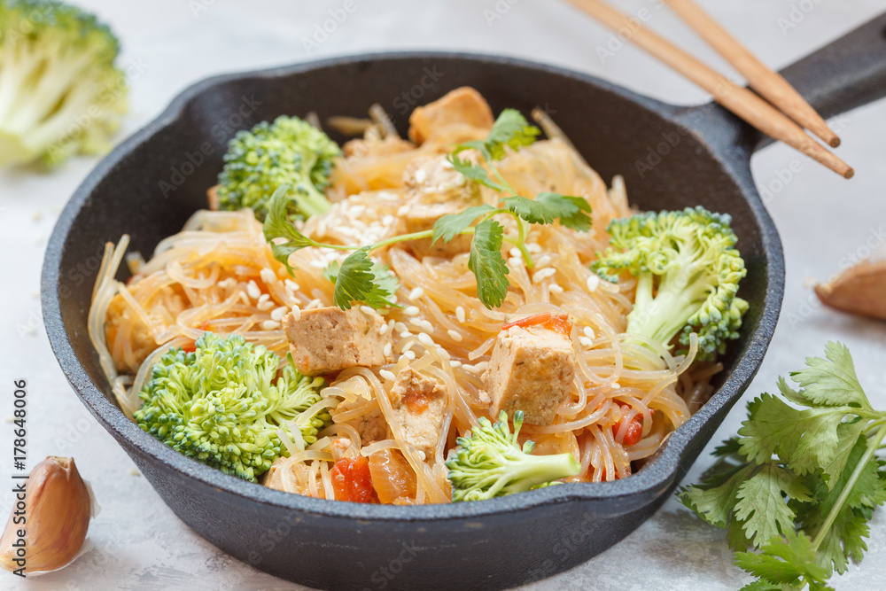 Fried vegan rice noodles with tofu and broccoli Fried vegan rice noodles with tofu and broccoli