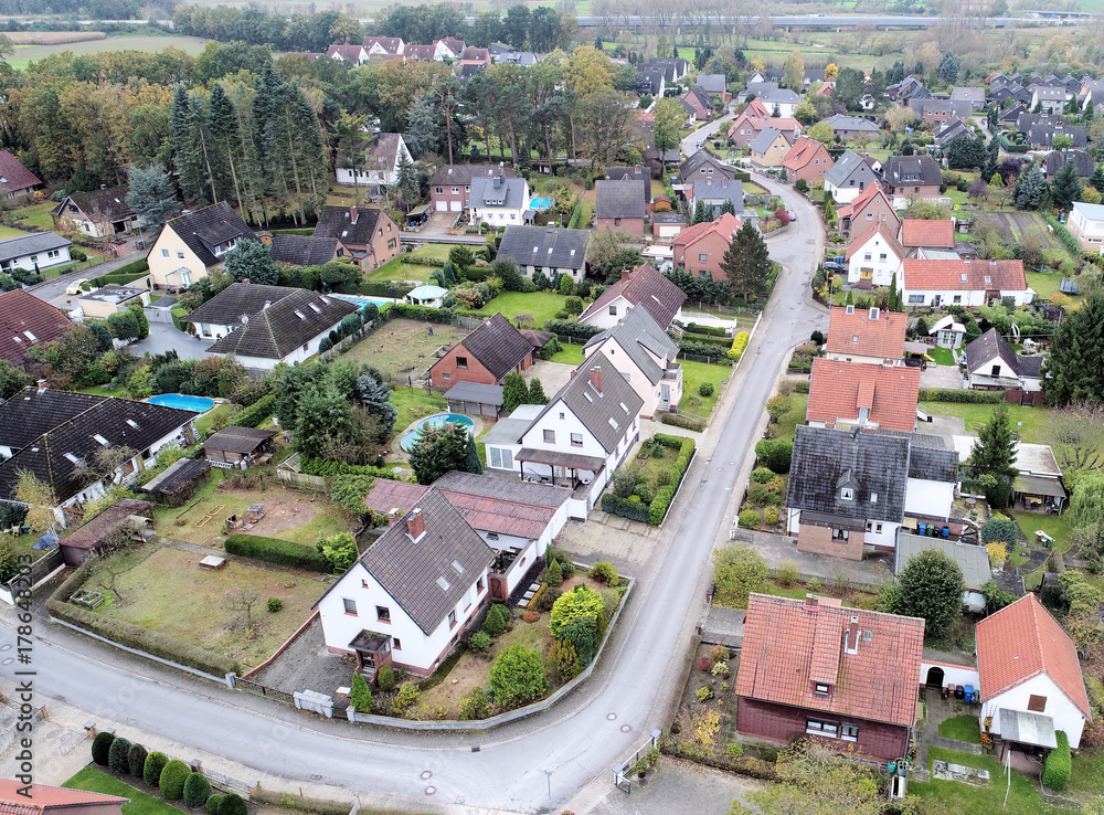 Suburban settlement in Germany with terraced houses, home for many families, aerial view with drone