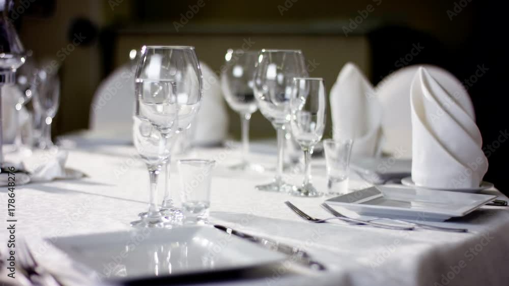 Shot of beautiful dinnerware and cutlery on a banquet table at restaurant Shot of beautiful dinnerware and cutlery on a banquet table at restaurant
