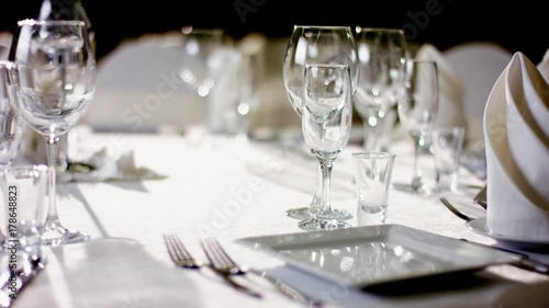 View of glasses and furniture on dinner table at restaurant photo