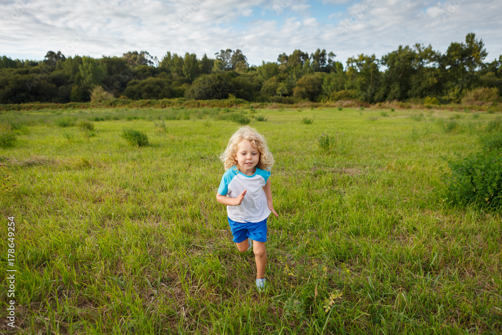 Small child with long blond hair enjoying Small child with long blond hair enjoying