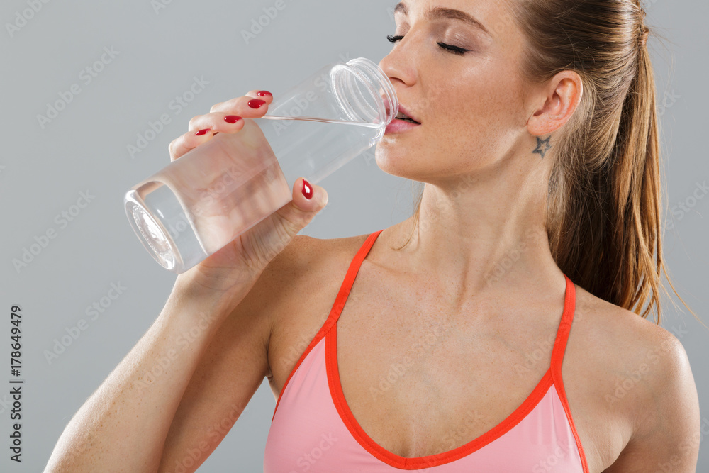 Close up portrait of healthy young sports girl drinking water Close up portrait of healthy young sports girl drinking water