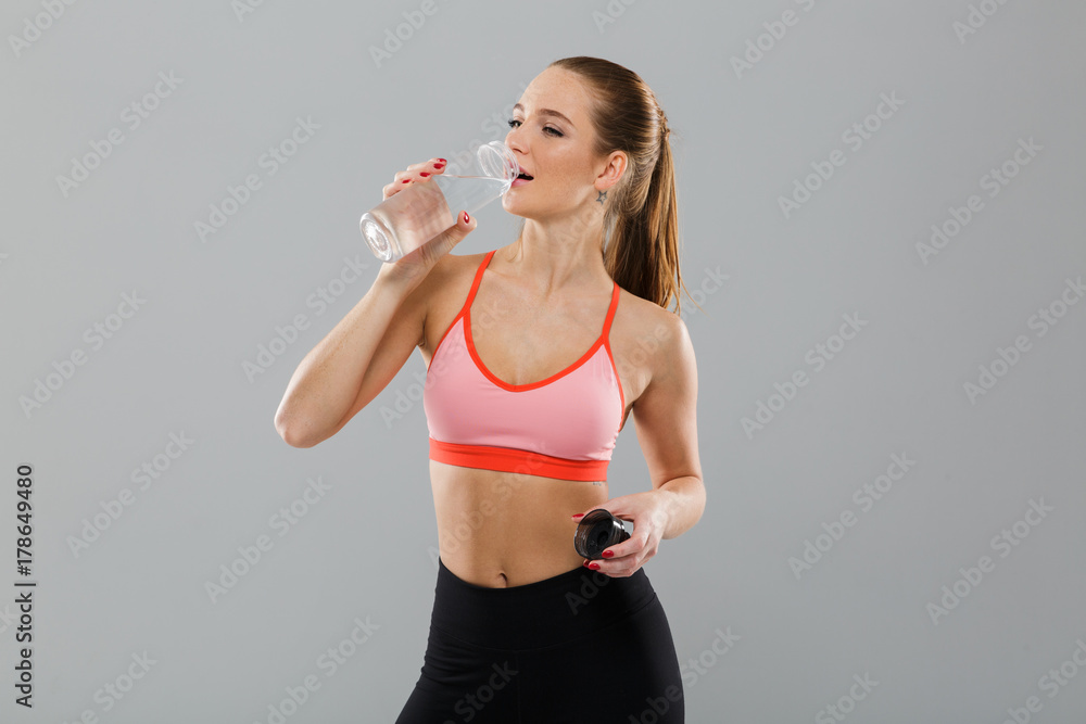 Portrait of pretty young sports girl drinking water Portrait of pretty young sports girl drinking water