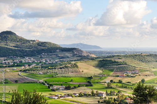 Castellabate, Italy - scenic view of the green hills, lands, sky and clouds photo