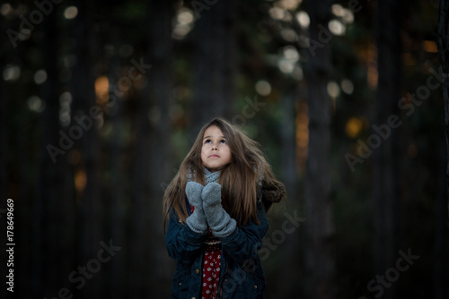 Girl in a forest waiting for Christmas