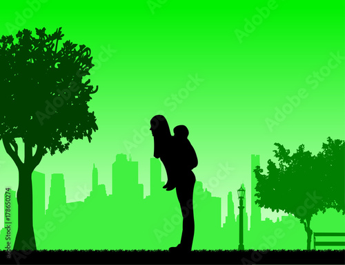 Mother carrying a child piggyback in park, one in the series of similar images silhouette