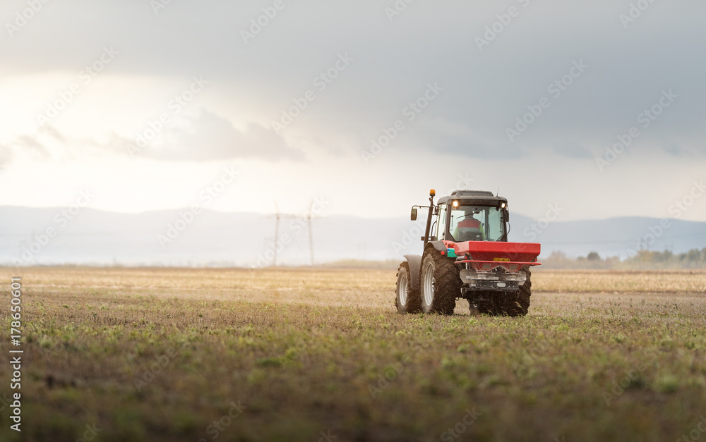 Tractor spreading artificial fertilizers Tractor spreading artificial fertilizers