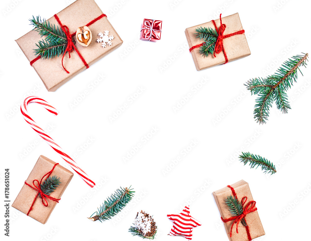 Christmas wooden background with gift boxes, pine cones, fir branches and xmas decorations on wooden white table. Flat lay, top view.