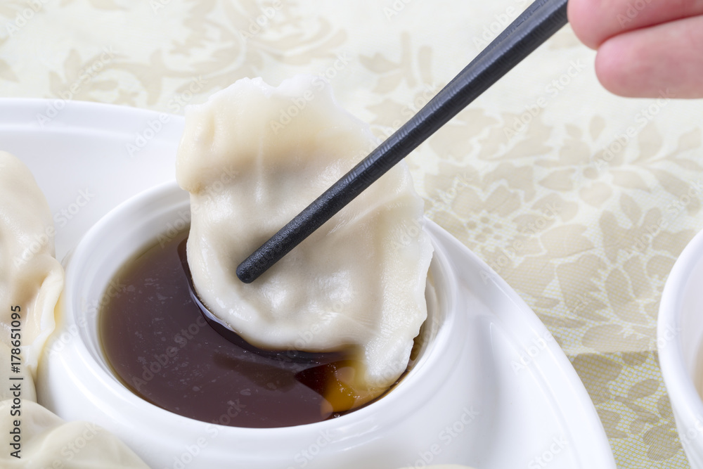 Closeup dumpling with chopsticks and sauce. Closeup dumpling with chopsticks and sauce.