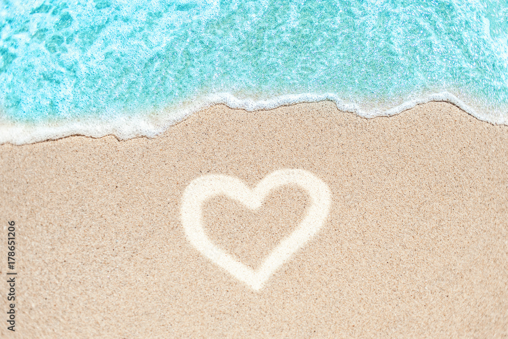 Sea Beach and Sand in summer day  with love heart shape sign on sand. Blue Ocean Wave  Textured  Background..