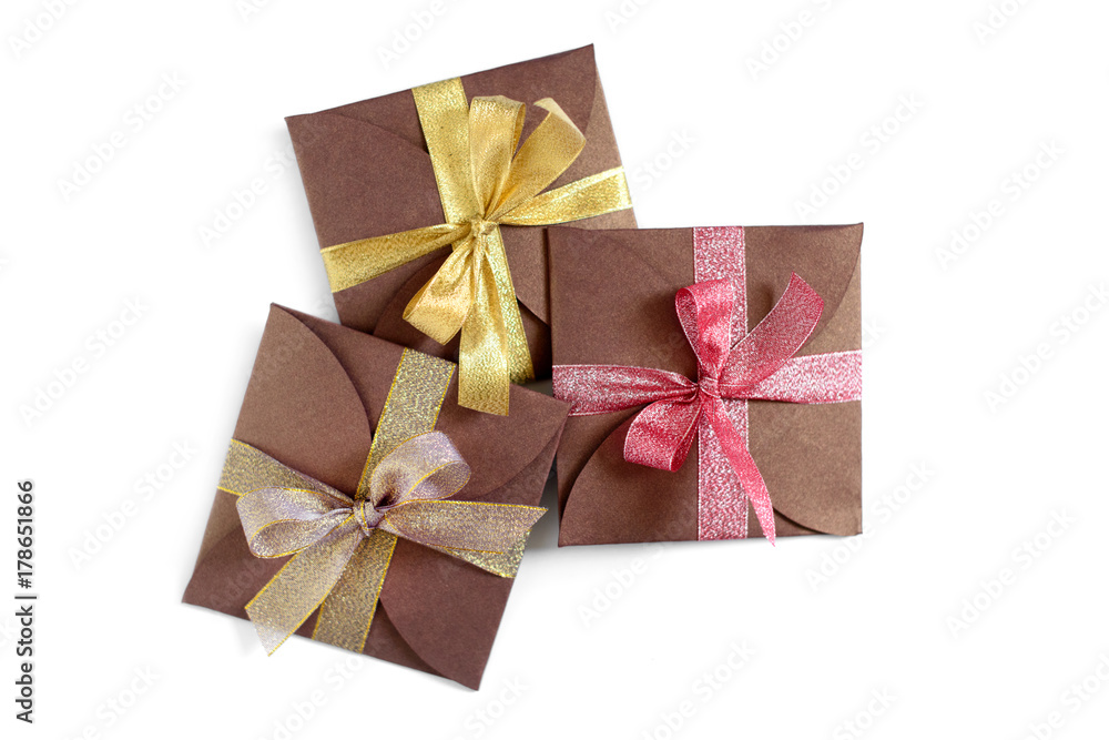 Christmas gifts wrapped in brown paper with the bow top view isolated on white background Christmas gifts wrapped in brown paper with the bow top view isolated on white background