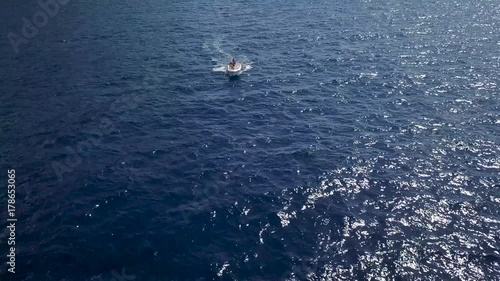 Wallpaper Mural Aerial survey of a couple on a boat travel together on a warm summer day. Woman driving a motor boat Torontodigital.ca