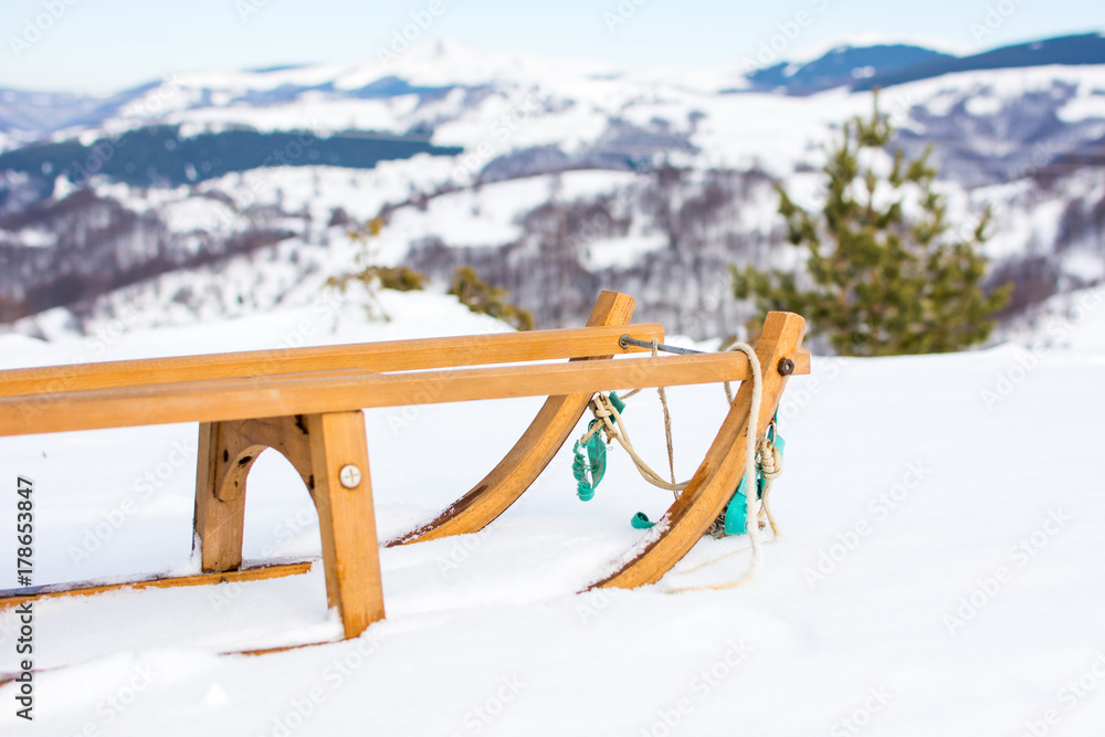 Wooden sleds on snow covered mountain - obrazy, fototapety, plakaty 