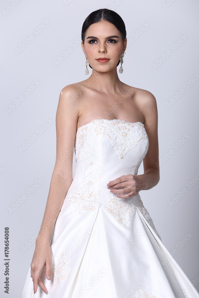 Lovely Caucasian Beautiful Woman bride in white wedding gown dress with lace, black hair Lovely Caucasian Beautiful Woman bride in white wedding gown dress with lace, black hair