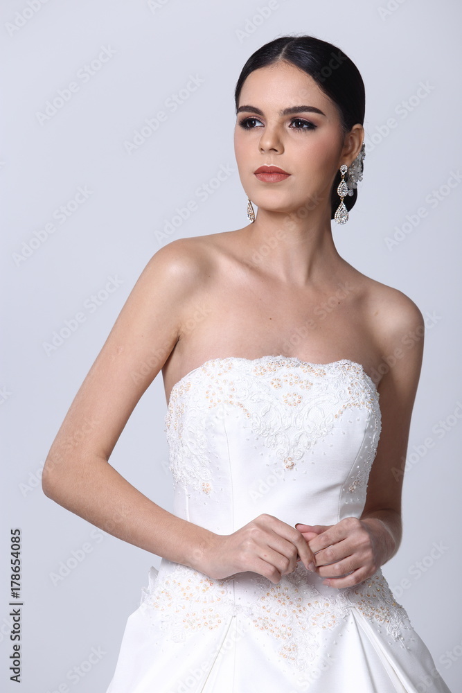 Lovely Caucasian Beautiful Woman bride in white wedding gown dress with lace, black hair Lovely Caucasian Beautiful Woman bride in white wedding gown dress with lace, black hair