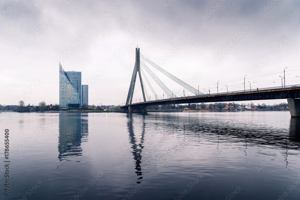 Winter in Riga, cloudy weather and view of the bridge over the river
