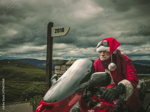 Trip of Santa Claus in Scotland on a hevy motorcycle. photo
