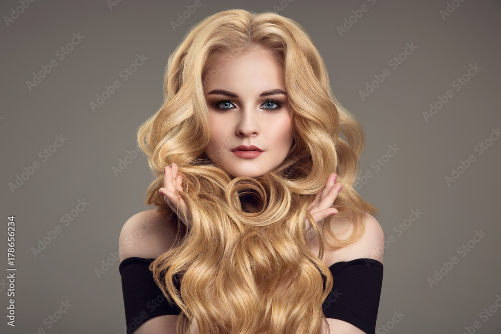 Naklejka premium Blond woman with long curly beautiful hair.