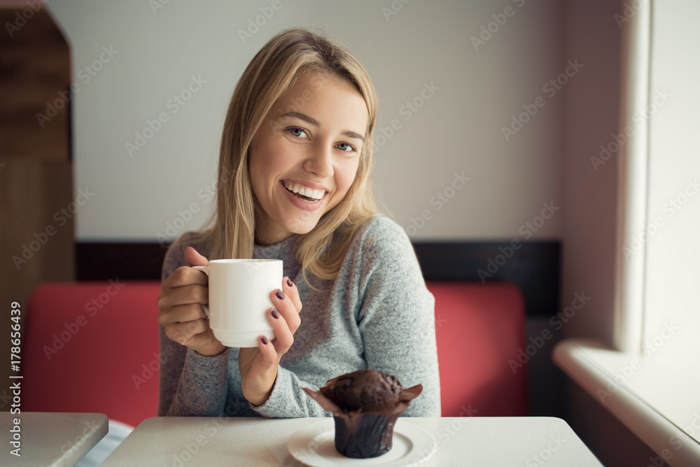 Young woman drinking coffee in cafe Young woman drinking coffee in cafe