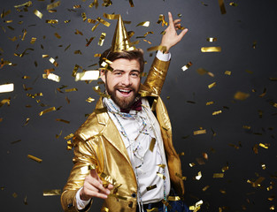 Businessman dancing among falling confetti