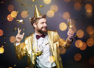Happy man dancing with champagne