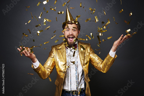 Portrait of Screaming man throwing confetti