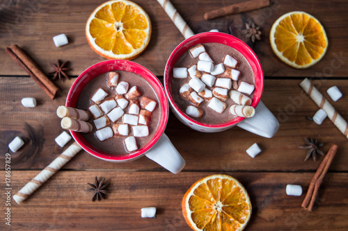 Christmas hot chocolate with marshmellow on old wooden background
