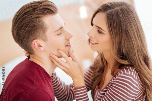 Romantic young people smiling before kiss