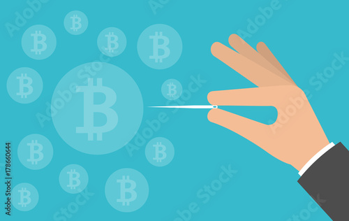 Hand bursting or pricking bitcoin bubble with a needle