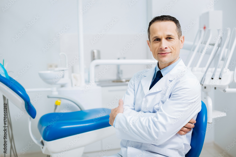 Handsome delighted doctor looking at you Handsome delighted doctor looking at you