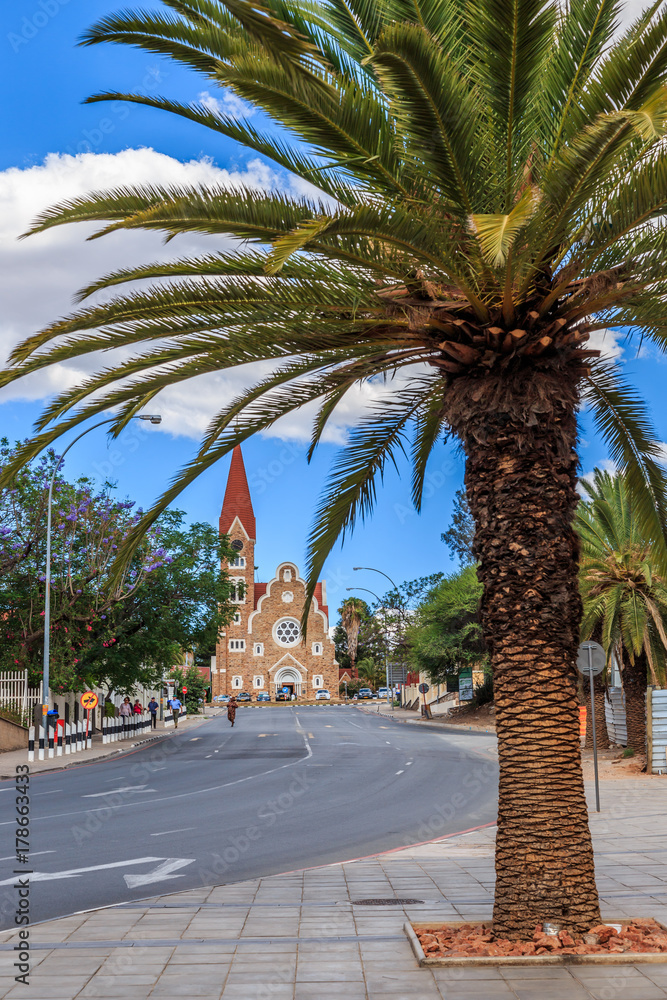 Palm trees along the  road and Luteran Christ Church in the end, central street of Windhoek, Namibia