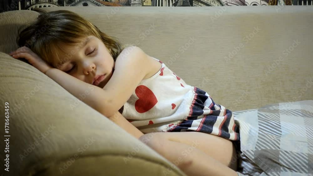 4K footage. Sleeping baby. A girl 4-5 years old in a dress fell asleep without undressing.