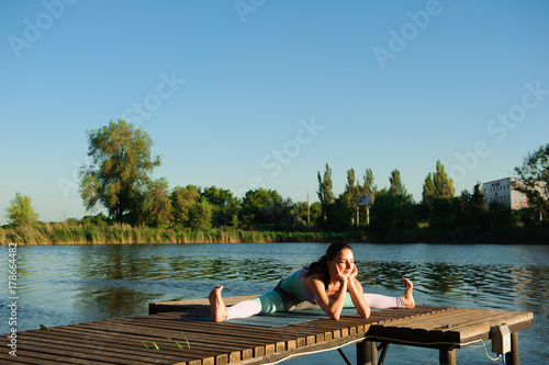 Healthy woman lifestyle balanced practicing meditate and energy yoga on the bridge in morning the nature. Healthy Concept.