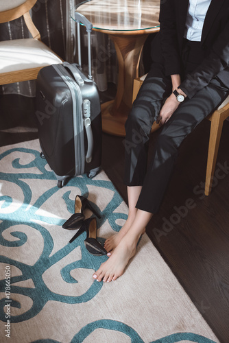 businesswoman with high heeled shoes in hotel room