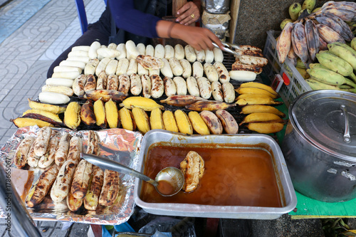 Local seller make Roasted Pisang Awak banana and  musa silver bluggoe banana at Saphan Khwai, Bangkok, Thailand photo