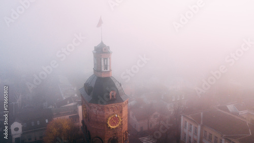 фотографія European city center of Vinnytsia covered in fog or mist with doves flying above