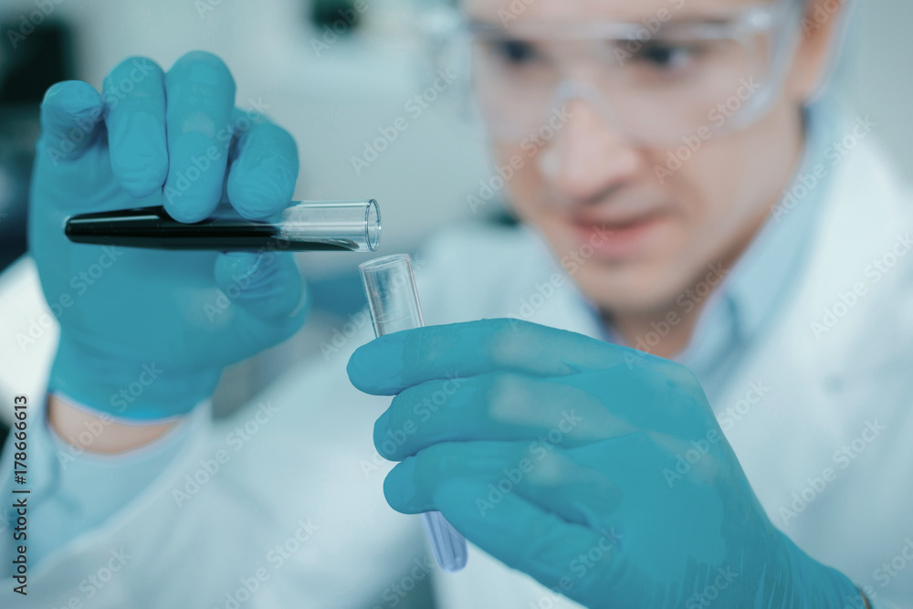 Close up of male hands that holding test tubes Close up of male hands that holding test tubes